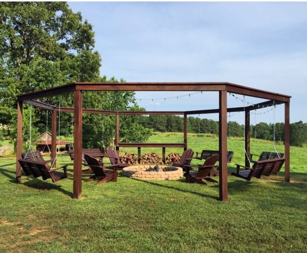 This is the perfect outdoor retreat for summer! (and spring and fall too!) Get the full detailed tutorial for this awesome porch swing pergola-style structure with a firepit and add-on movie screen option. 