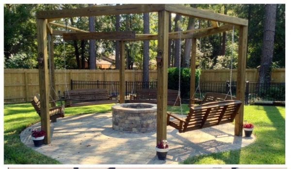 Tutorial for round pergola with fire pit and swings featured on @Remodelaholic