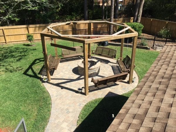 Tutorial for round pergola with swings and fire pit featured on @Remodelaholic