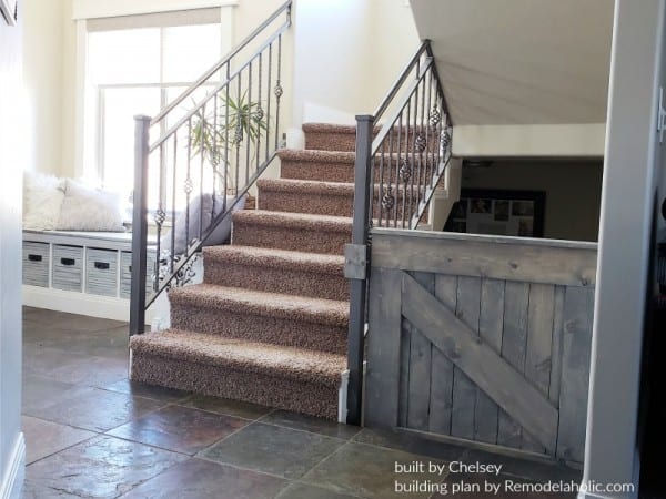 Wooden Barn Door Baby Gate Installed On A Metal Stair Banister, Built By Chelsey, Plans By Remodelaholic